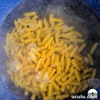 Fusilli (spiral) pasta cooking in a pot of water