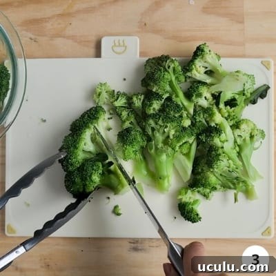 Cooked broccoli cut into small florets with a knife