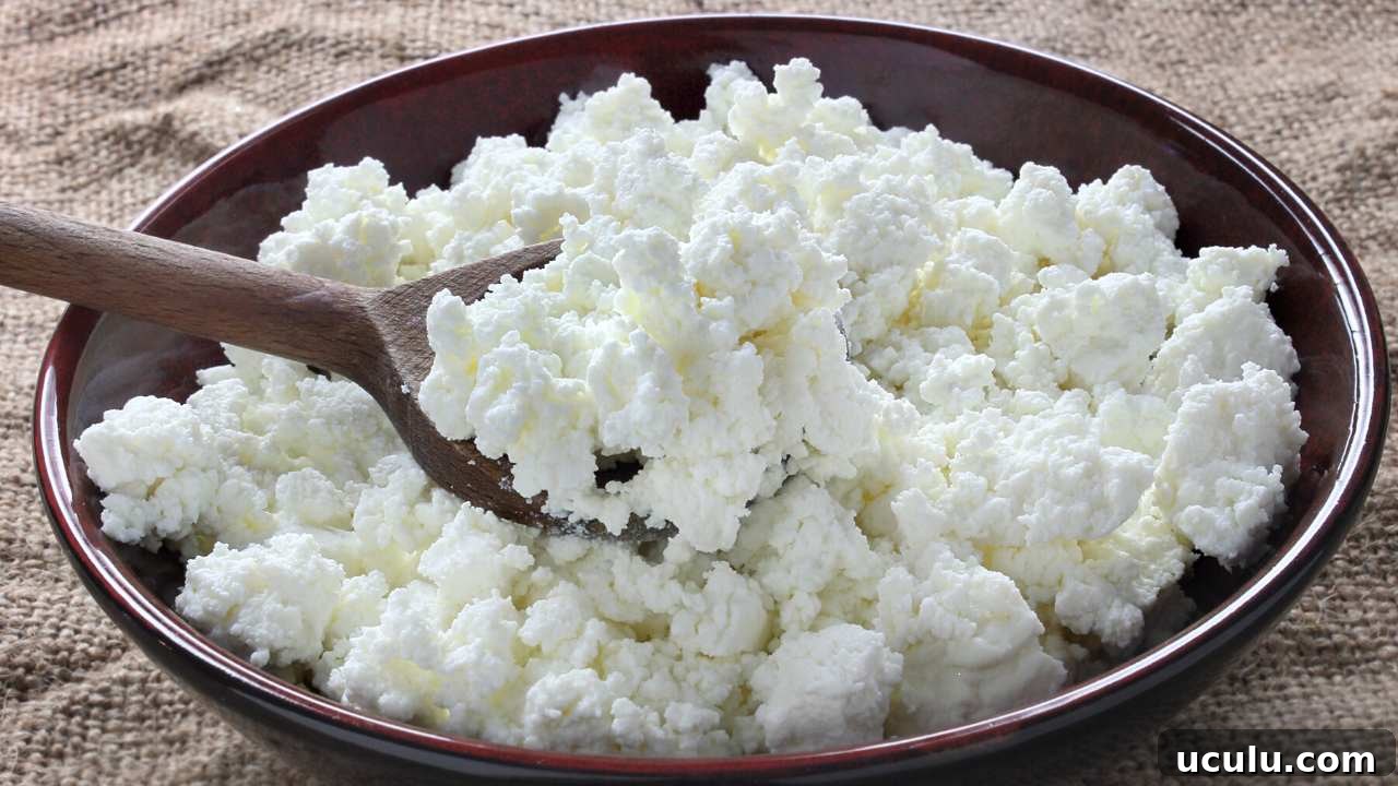 cottage cheese placed in a brown bowl with wooden spoon