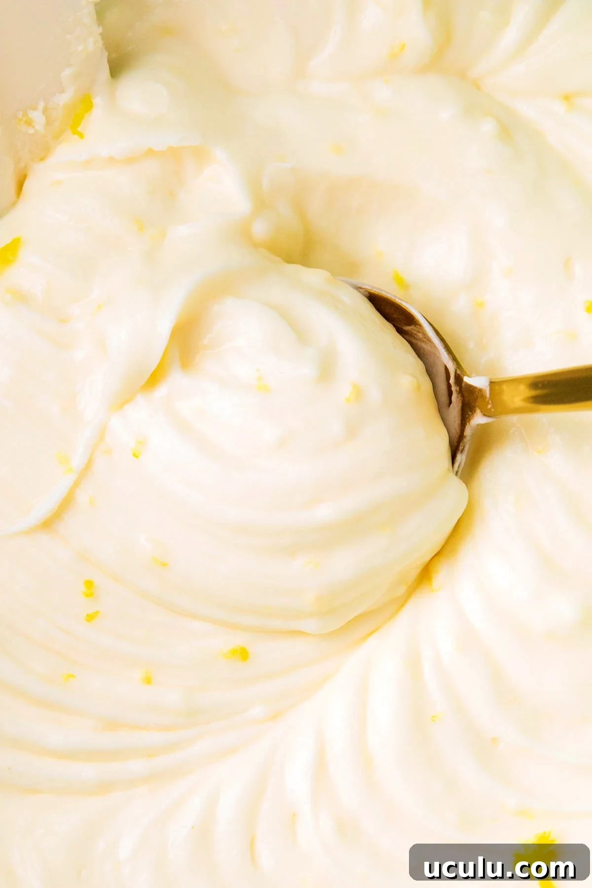 Close up of this cream cheese lemon frosting recipe with fluffy smooth texture.
