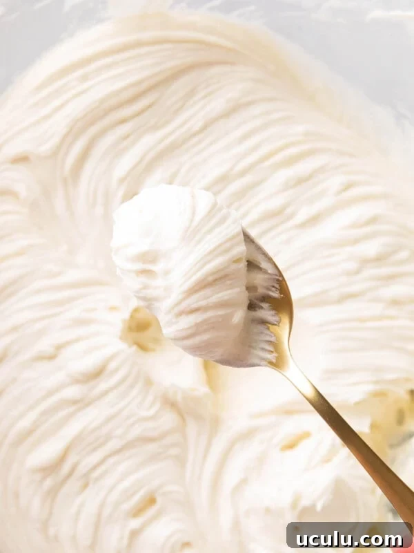 A spoon of thick rich and creamy Cream Cheese Frosting