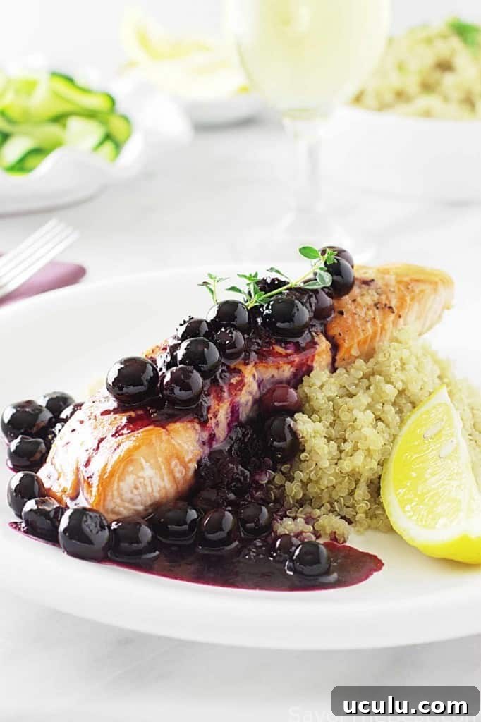 A salmon fillet topped with blueberry sauce. 
