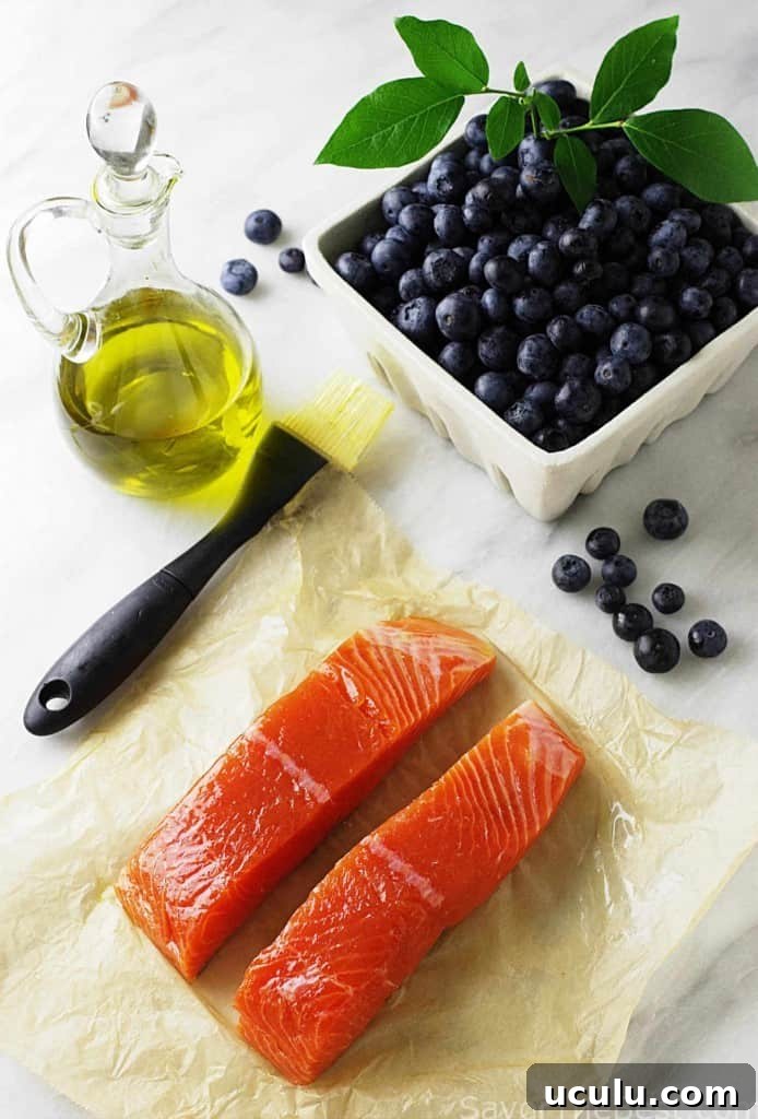 King salmon fillets with fresh blueberries and a jar of olive oil. 