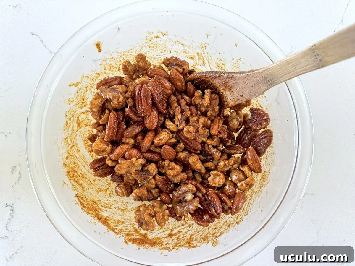 mixing nuts with spice-oil mixture