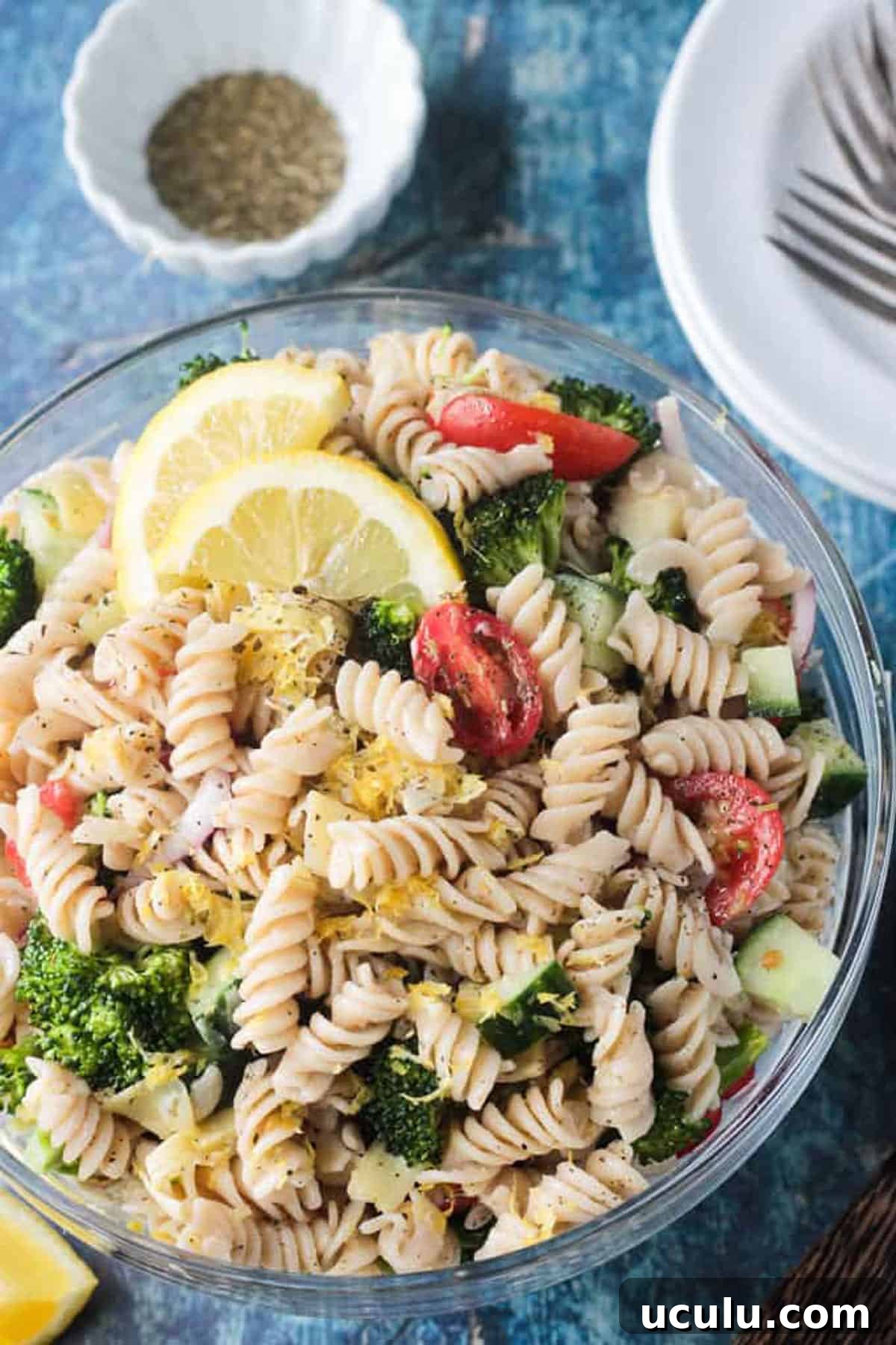 Close up of lemon zest on top of rotini pasta.
