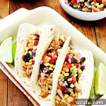 Three chicken tacos in baking dish.