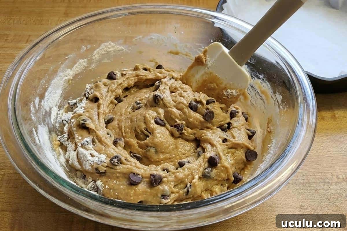 Folding in the flour, salt, and chocolate chips.