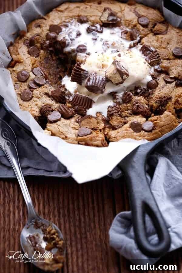 Reese's Nutella Stuffed Peanut Butter Chocolate Chip Deep Dish Skillet Cookie in a pan