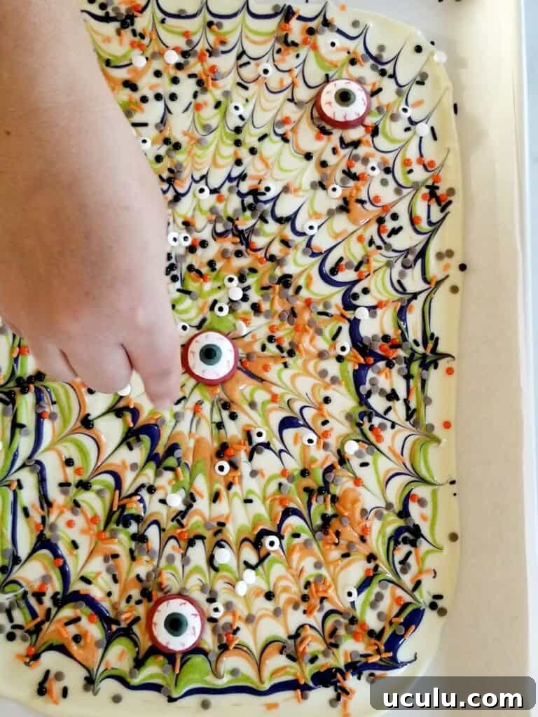 Decorating white chocolate bark with Halloween apprel