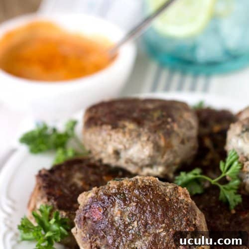 A bunch of rissoles on a plate.
