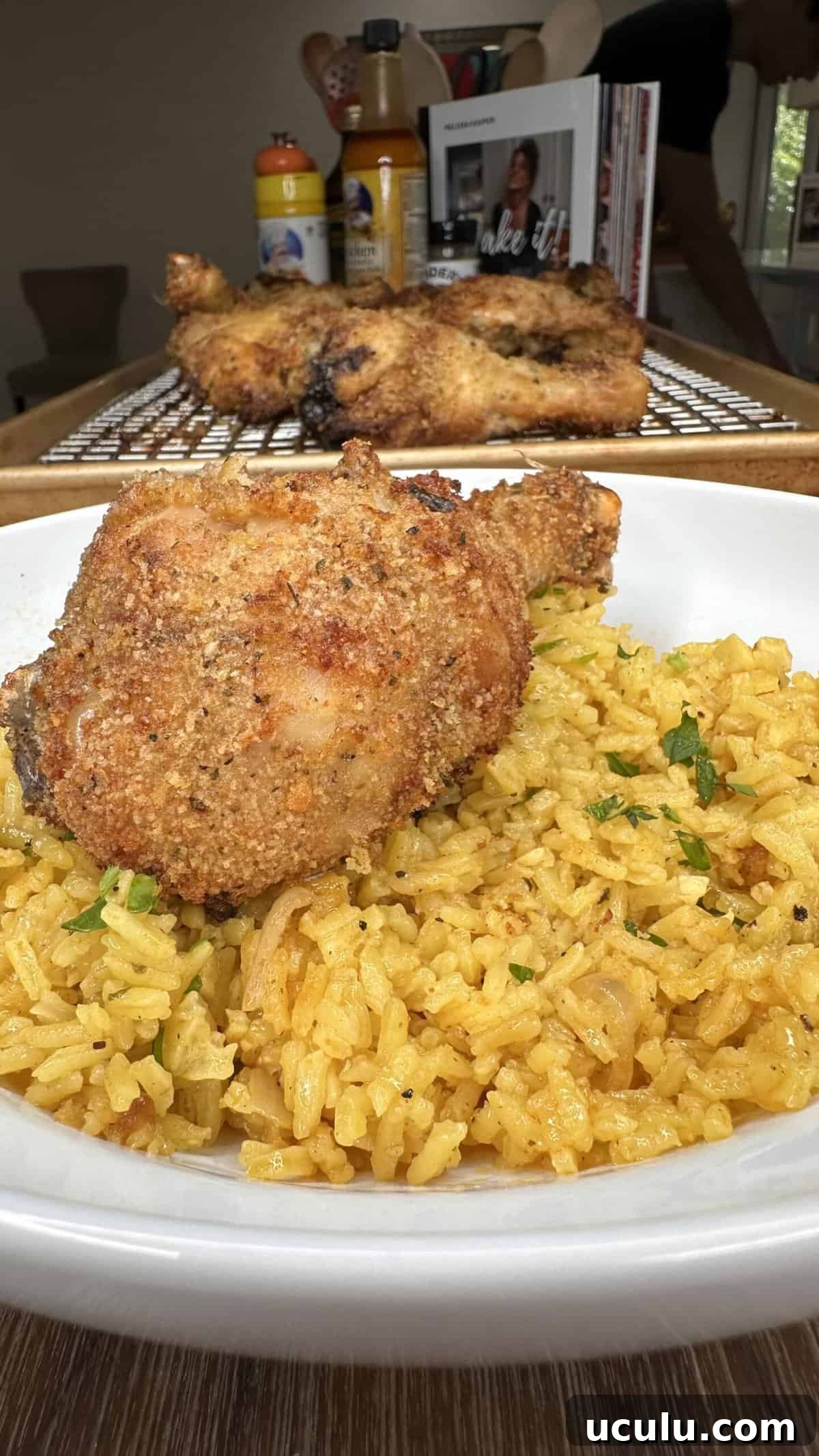 An image of the previous baked fried chicken, laid over the Lemon Pepper Rice.