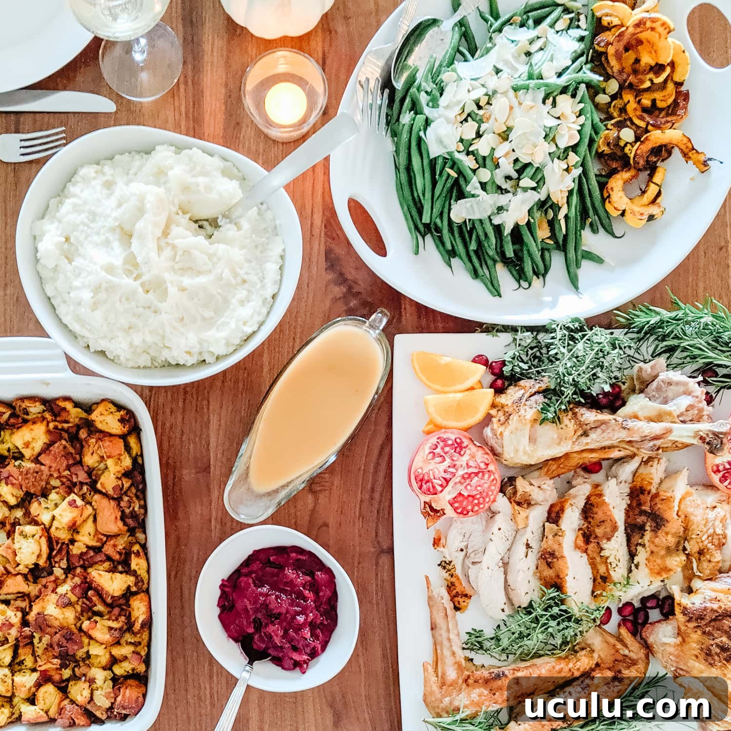 Overhead photo of a turkey dinner on a wood dining table.
