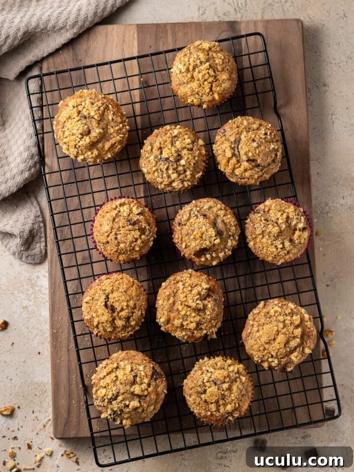 a dozen banana muffins on a cooling rack