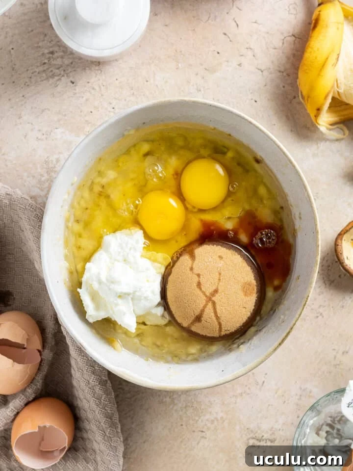 brown sugar, vanilla, eggs and sour cream added to bananas