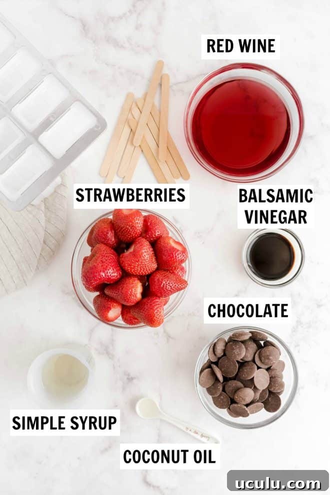 ingredients to make strawberry red wine popsicles sitting on a counter