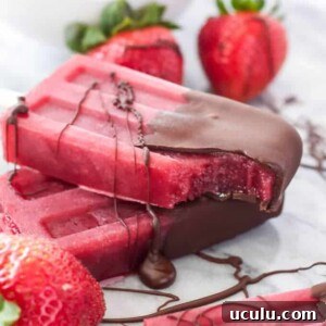 a wine popsicle with a bite taken out of it sitting on top of another popsicle on a counter