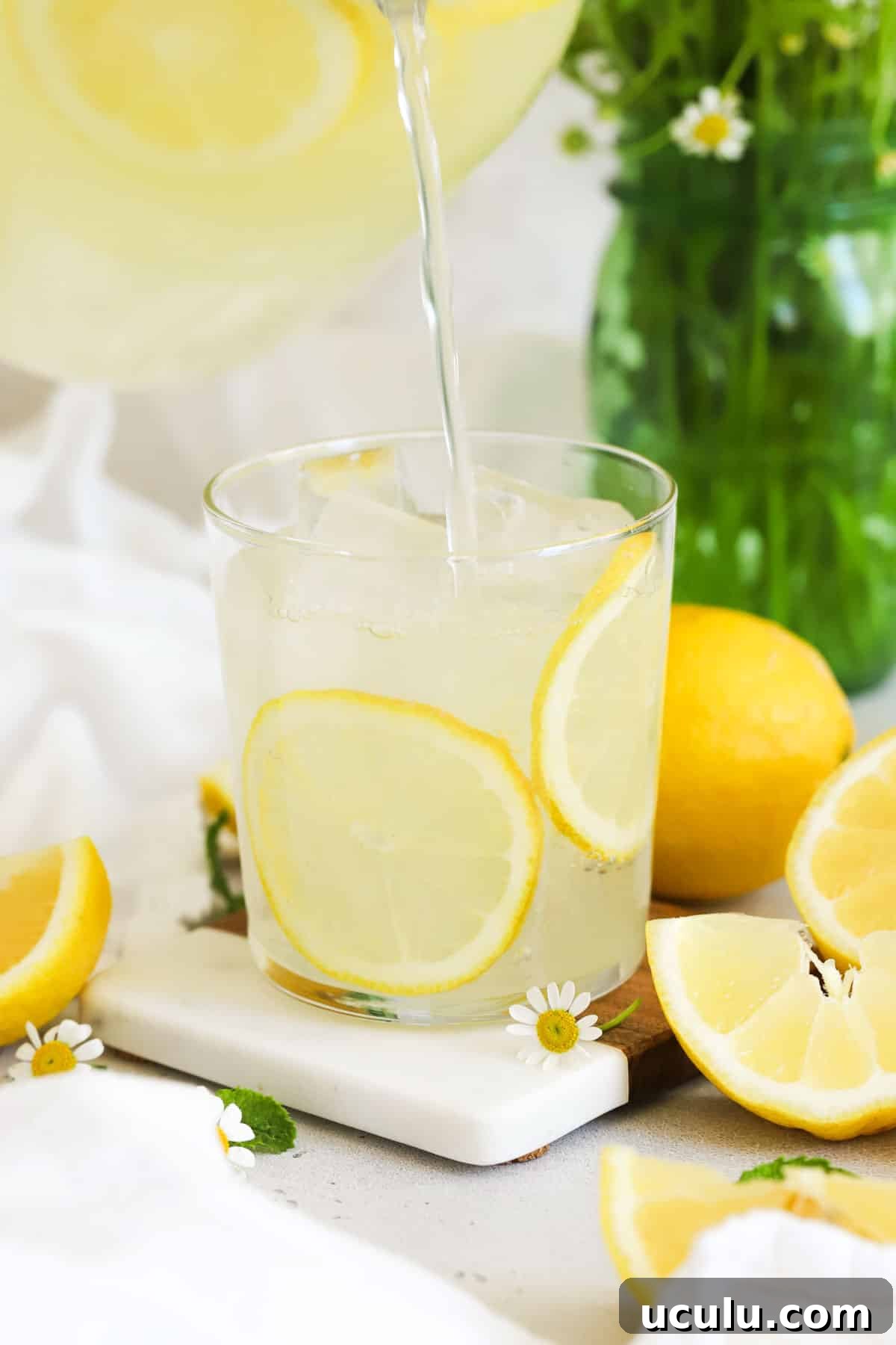 pouring homemade lemonade into a glass