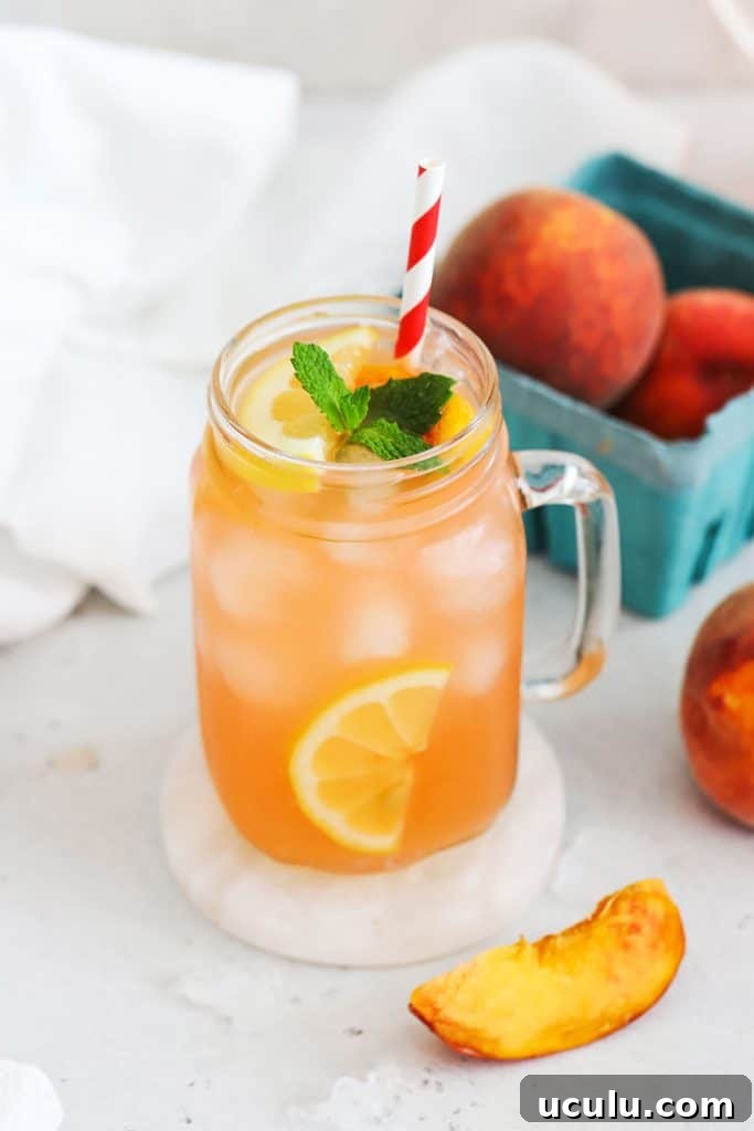 homemade peach lemonade in mason jar glasses