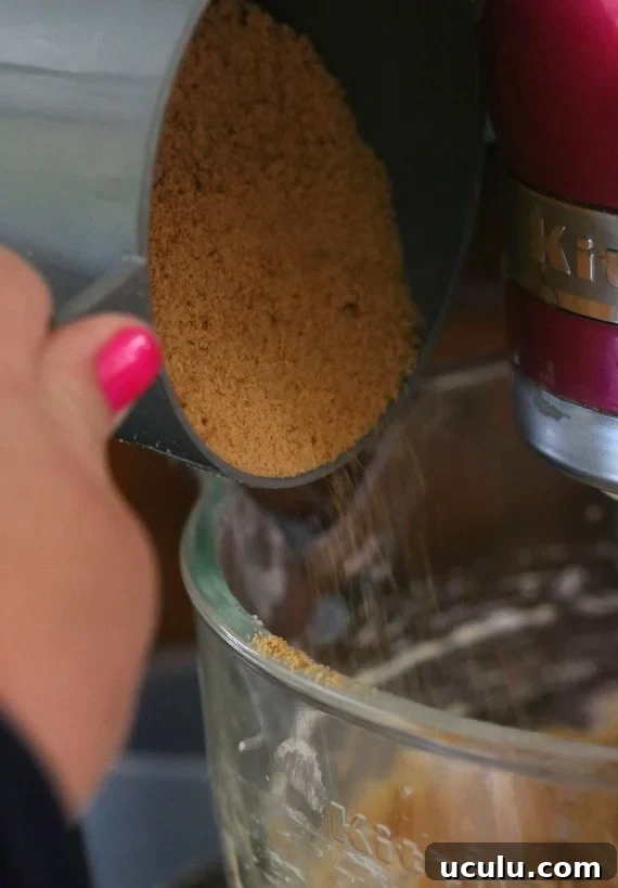 Pouring Graham cracker crumbs into the cookie dough