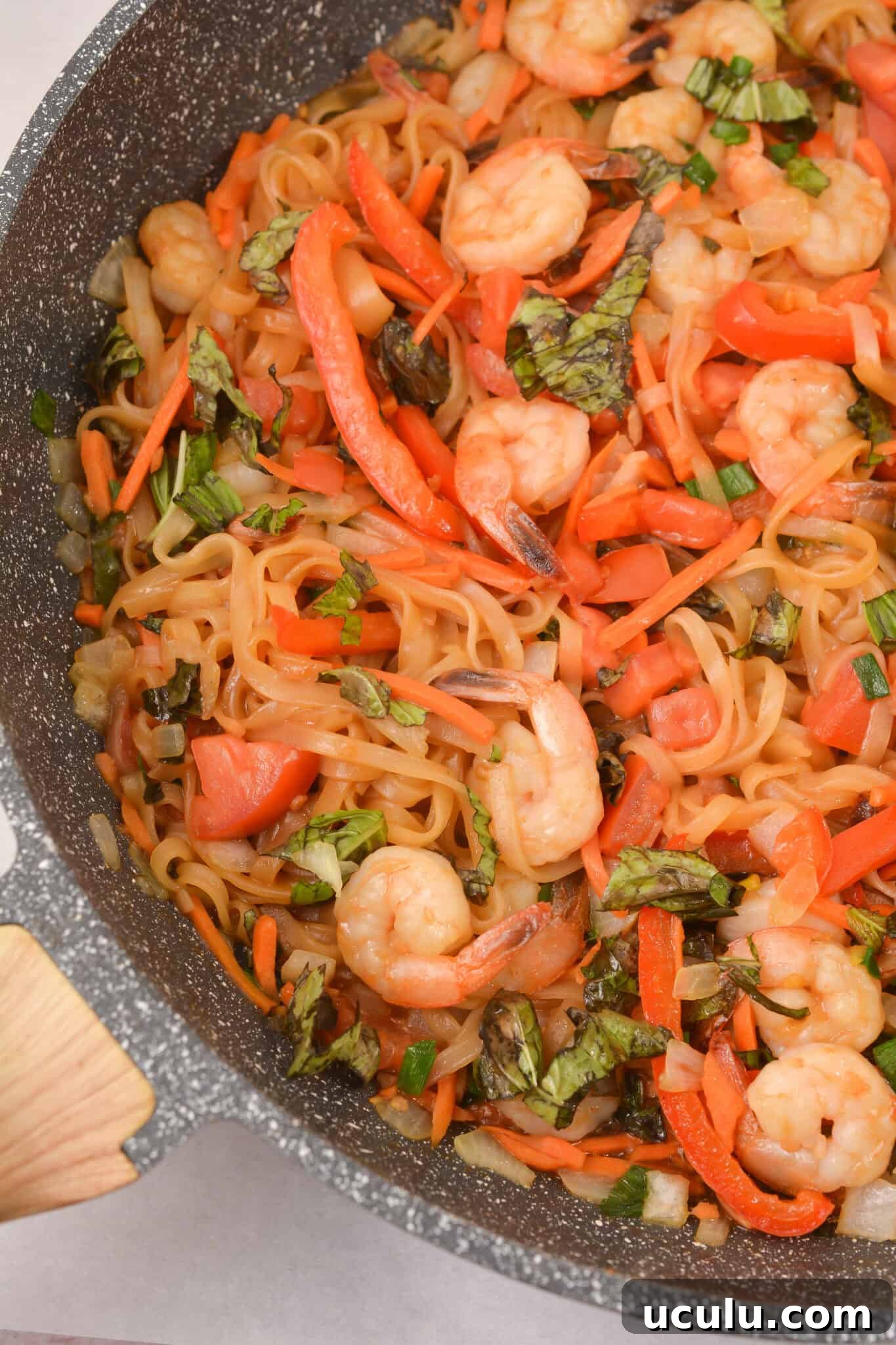 Shrimp drunken noodles in a pan.