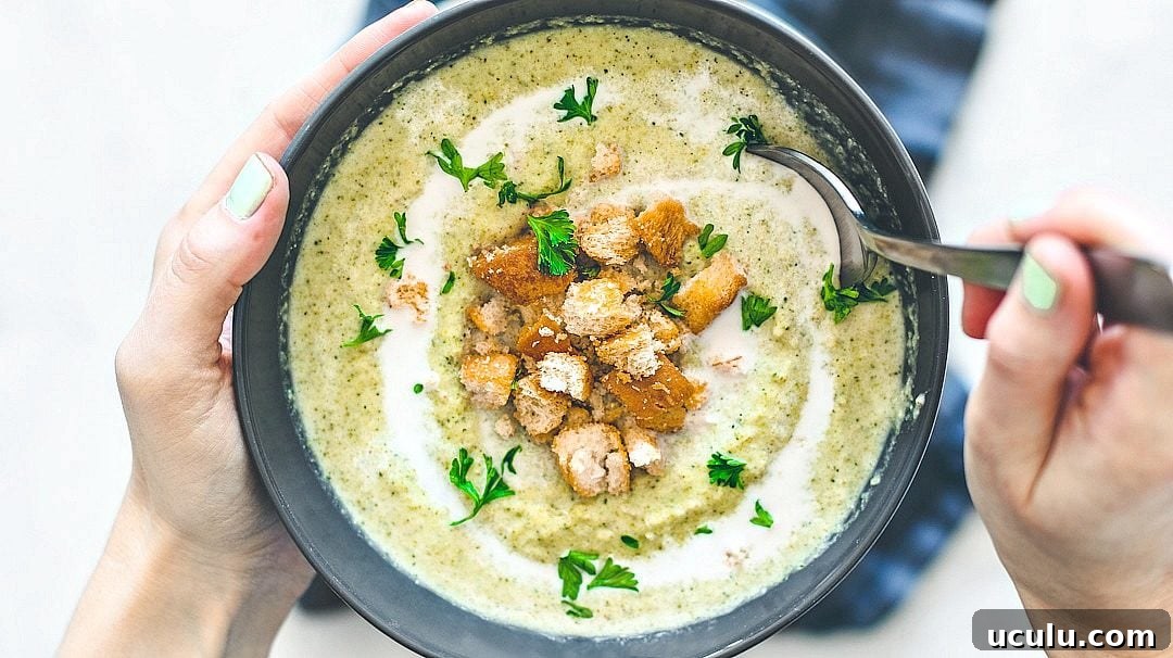 Spooning into cream of broccoli soup.