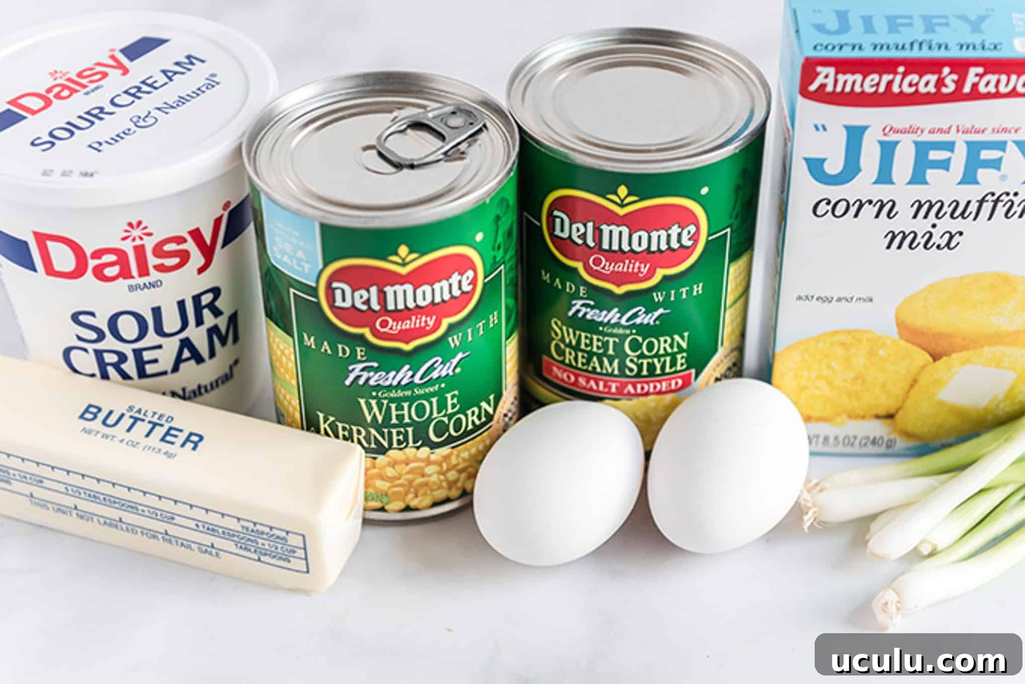 Ingredients to make corn casserole with Jiffy on the counter. 