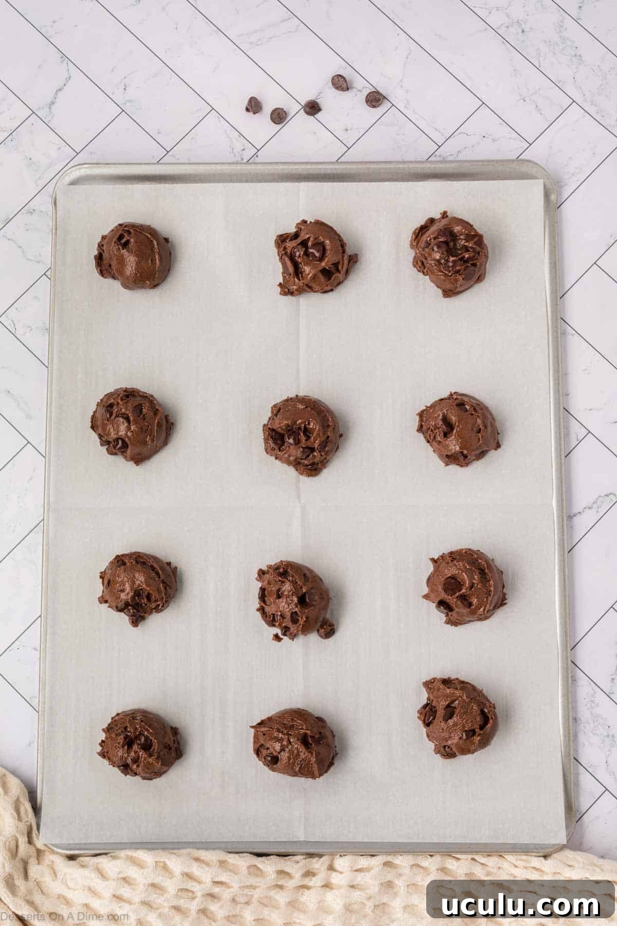 Cookie dough balls on baking sheet. 