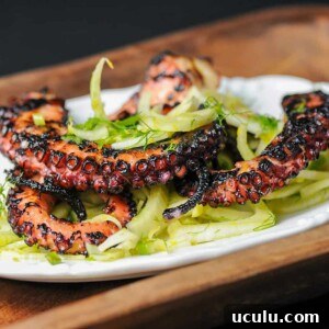 grilled octopus on a bed of greens.