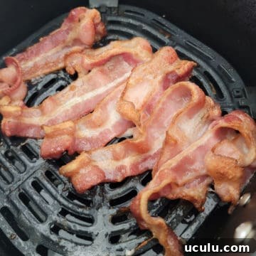 air fried bacon in an air fryer basket