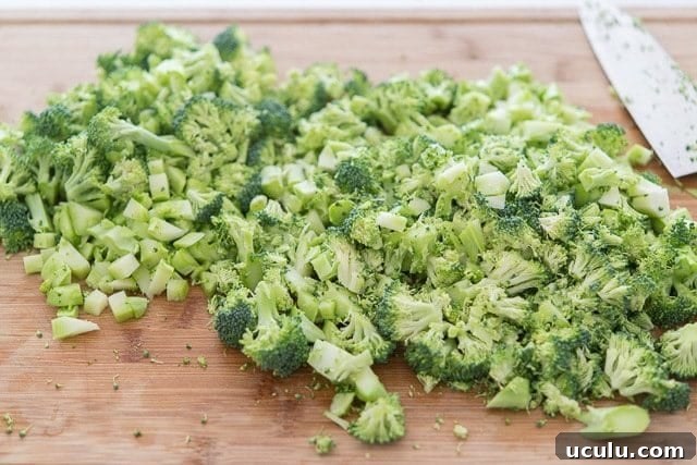 Fresh broccoli florets chopped on wooden board