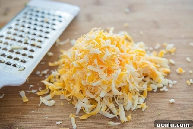 Grated Cheddar Cheese on Wooden Board
