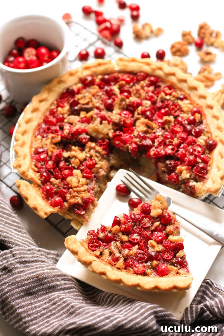 A slice of cranberry pie on a white plate.