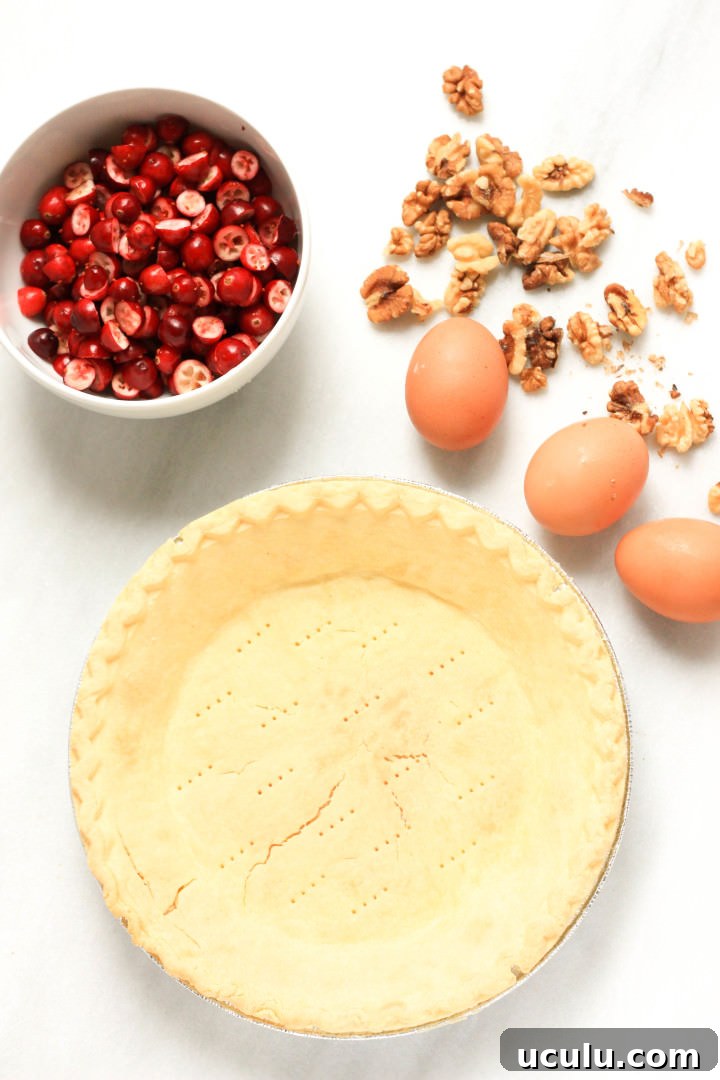 Ingredients for cranberry pie on a white board.