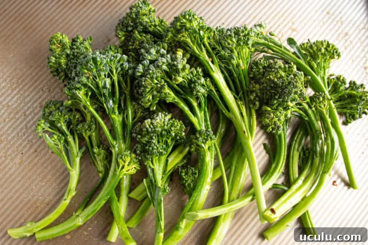 Trimmed broccolini on a cutting board.