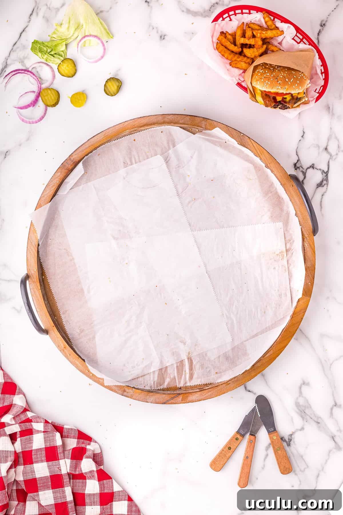 Overhead image of round wood platter with parchment paper