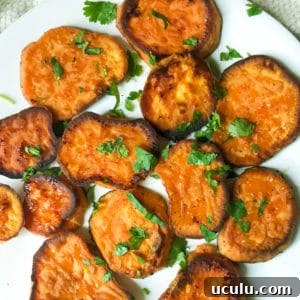 savory roasted sweet potatoes with blue cheese crumbles on a white plate
