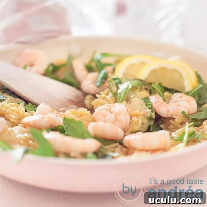 A square photo with a frying pan with risotto, shrimp and arugula.