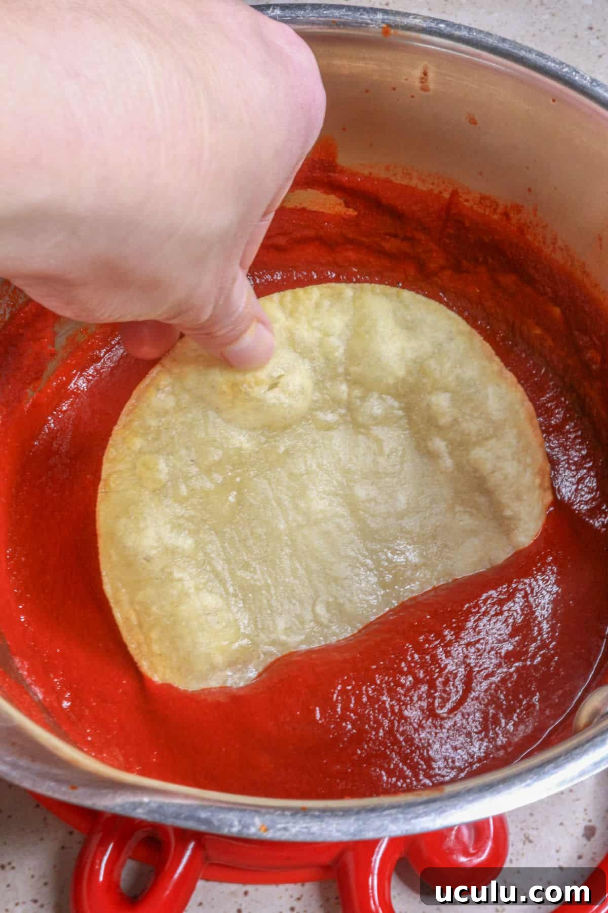 Dip each tortilla in enchilada sauce