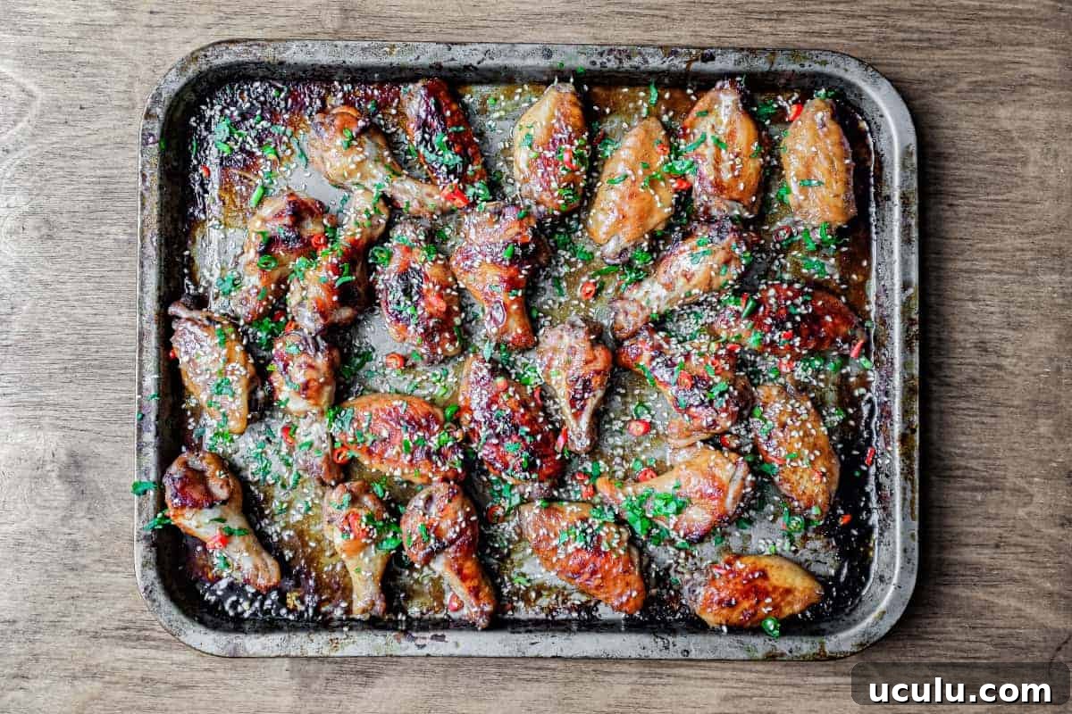 A baking sheet with Sticky Baked Chinese Chicken Wings