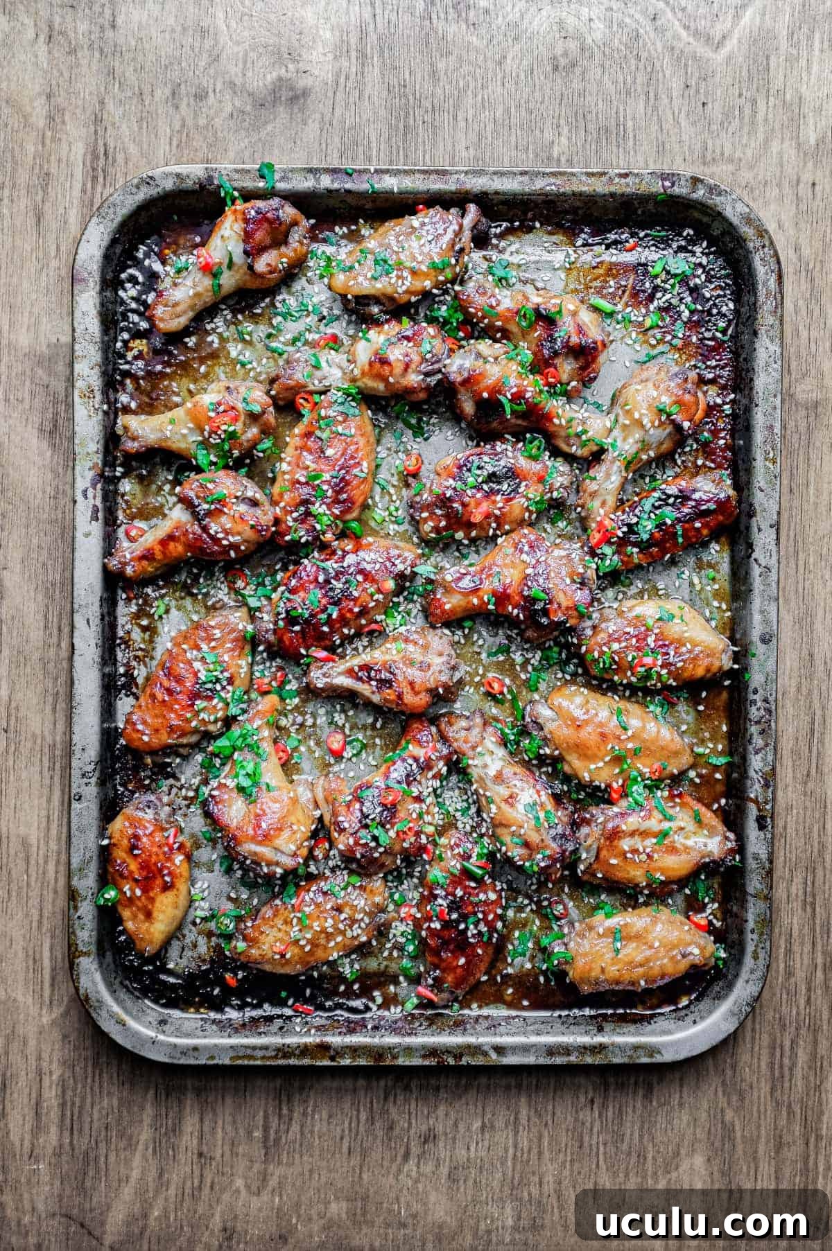 A baking sheet with Sticky Baked Chinese Chicken Wings
