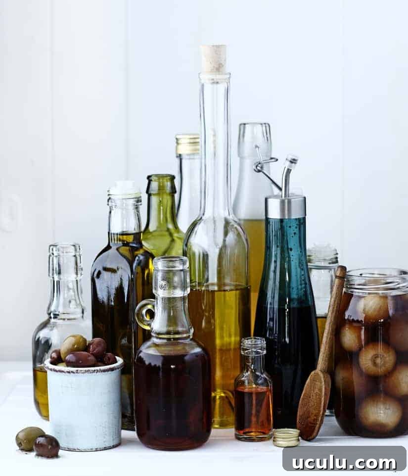 A selection of glass bottles holding oils and vinegars