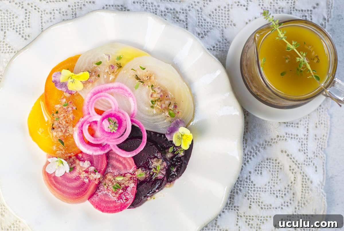 Four different colors of steamed beets with pickled onions and shallot-thyme vinaigrette in a bowl