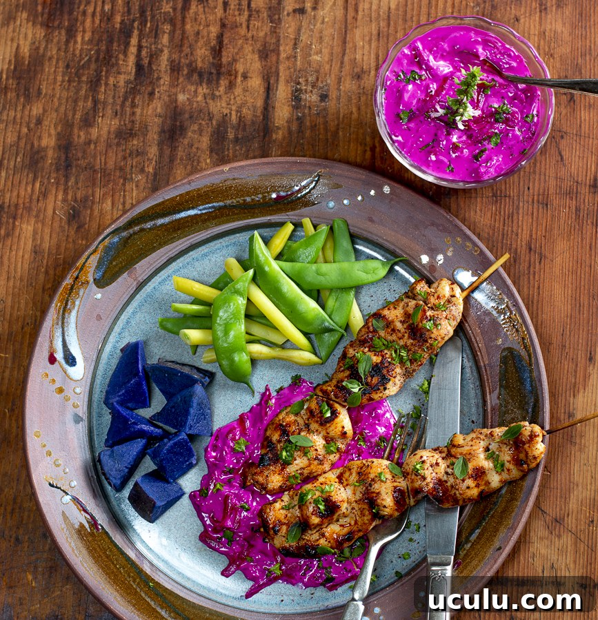Beet Tzatziki with Spiced Chicken Skewers on a vintage plate