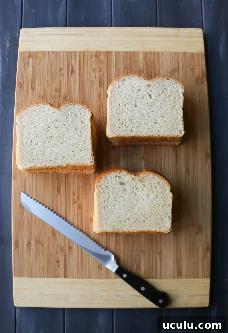 piles of sliced white bread on a cutting board