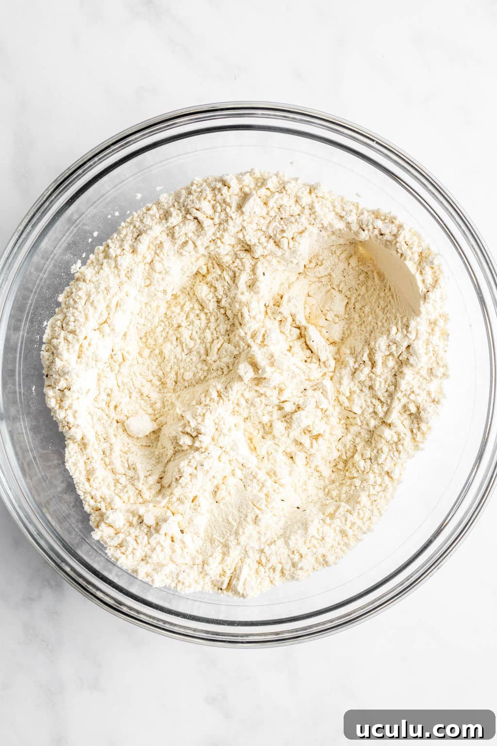 large glass bowl filled with flour.