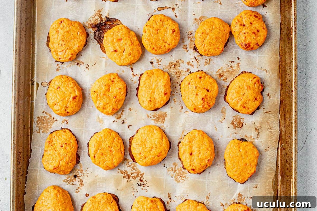 baked chicken nuggets on a sheet pan with parchment paper