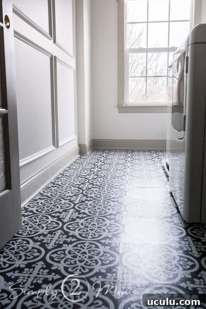 Finished laundry room floor with black and white wallpops peel and stick vinyl tile in Gothic pattern.