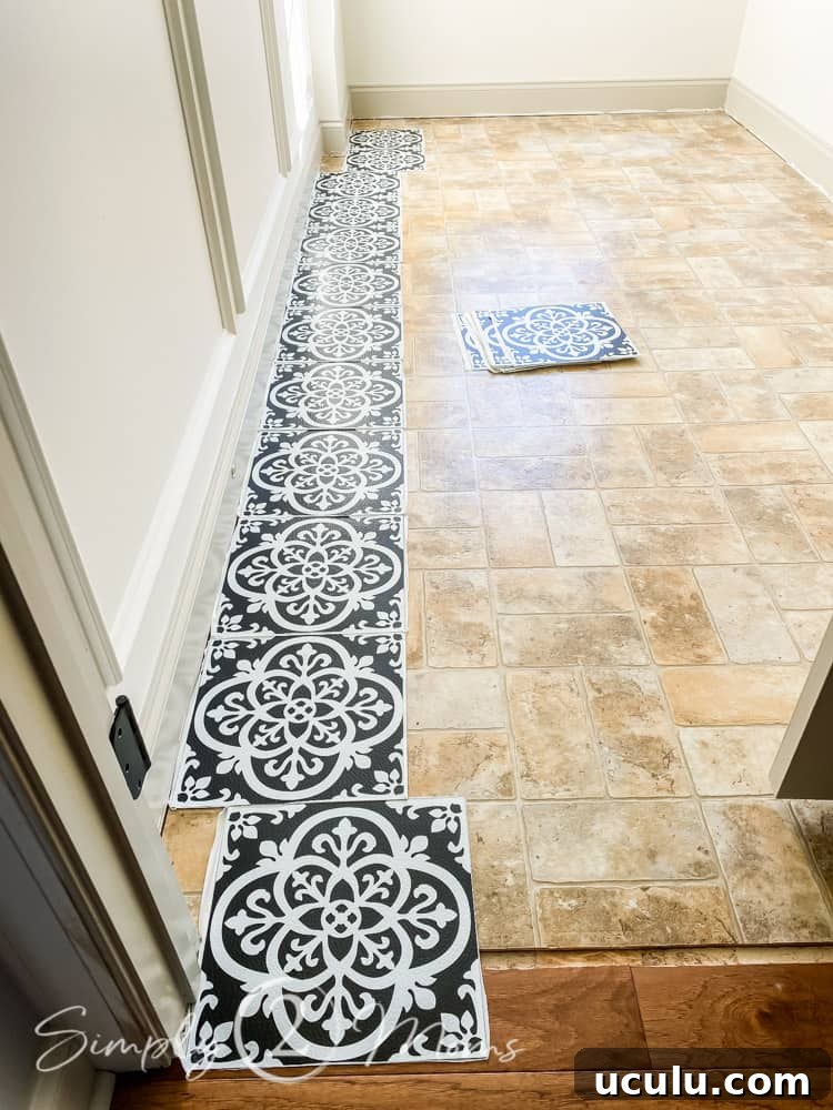 Lining up floorpops tiles along wall to plan placement in a laundry room with linoleum flooring.