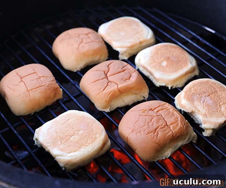 potato rolls on grill grate cut side down.