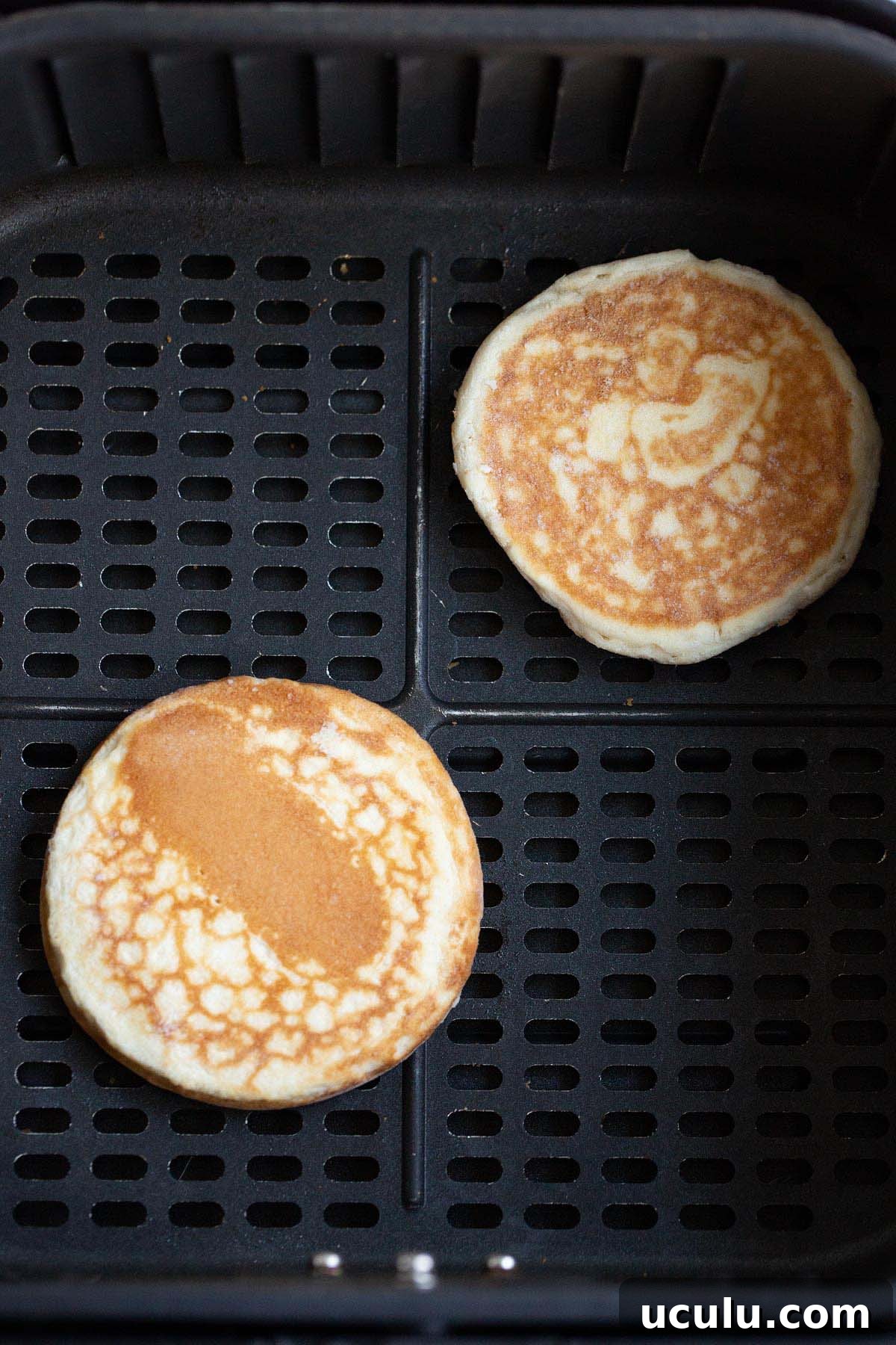 Uncooked griddle cakes in air fryer.
